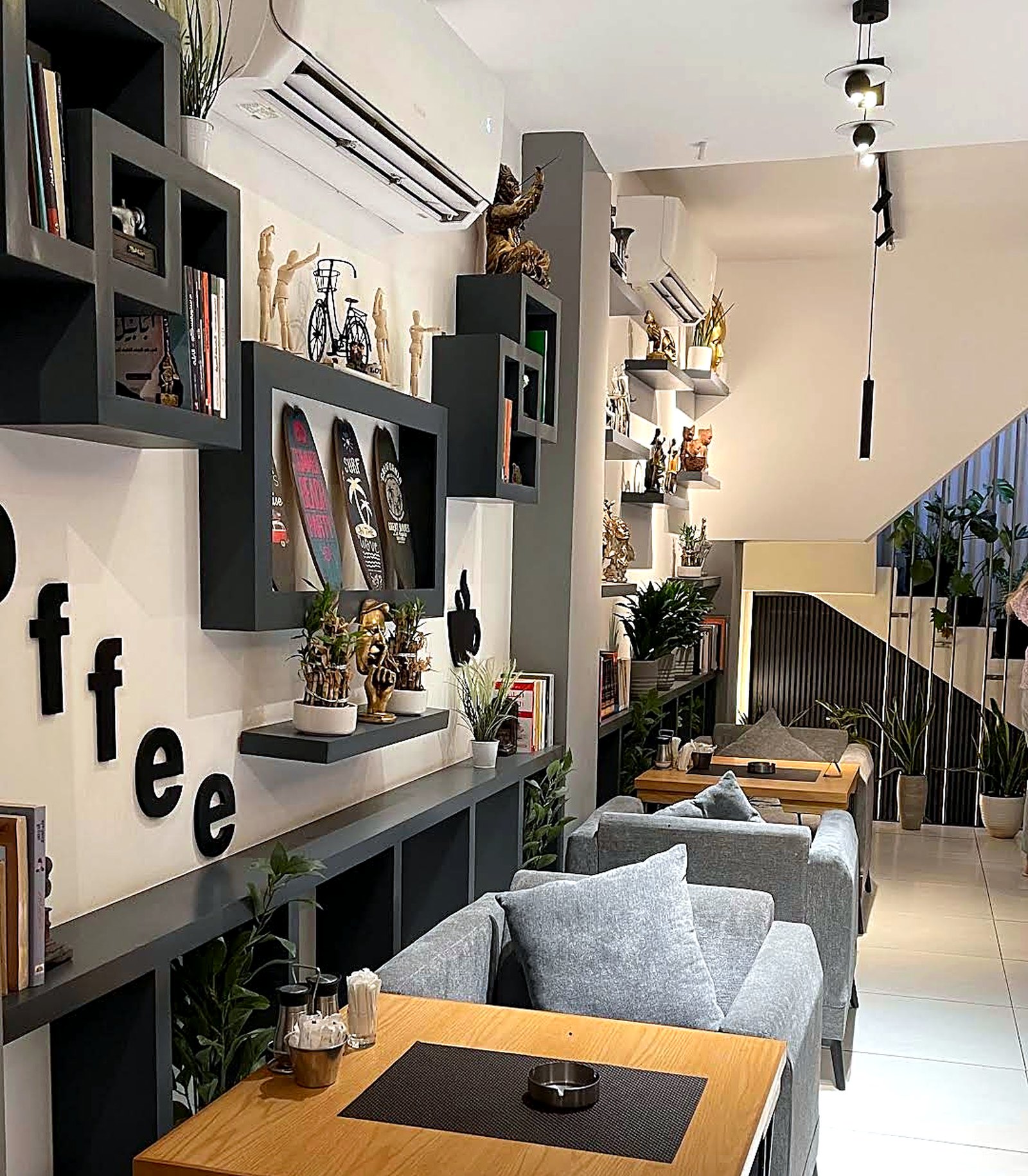 The coffee wall at KAN with lettering, shelving and softly lit seating